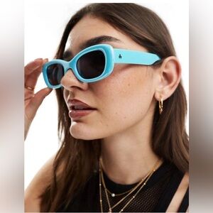 AIRE Bubble Oval Sunglasses in iridescent blue.